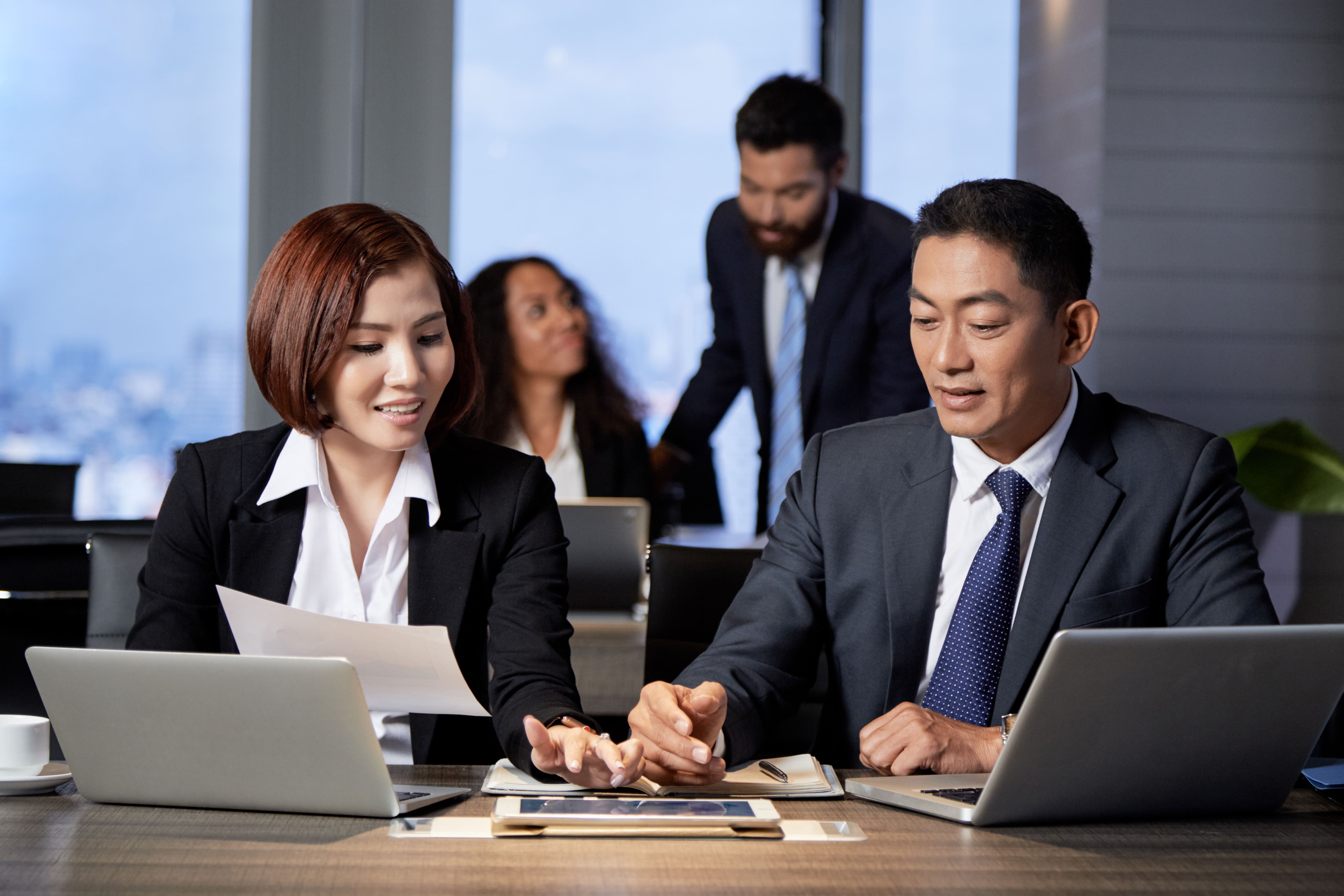 young-ethnic-coworkers-using-tablet